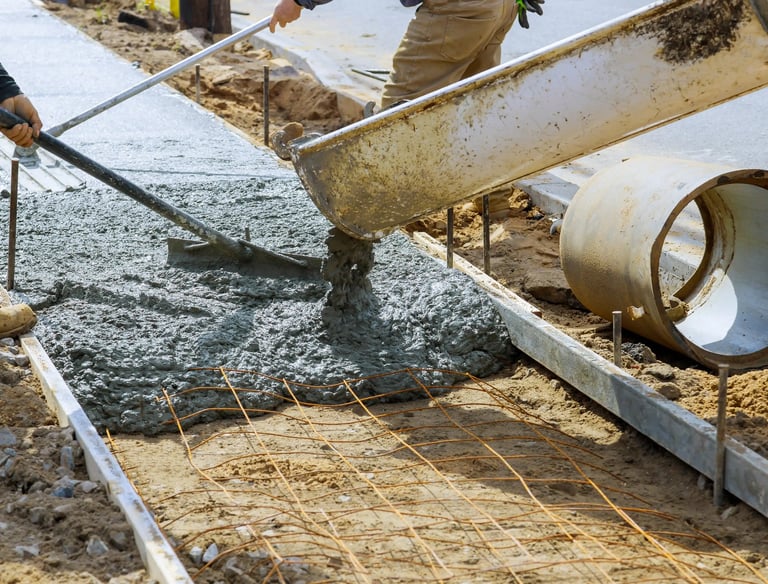 a man is pouring concrete into a concrete slab