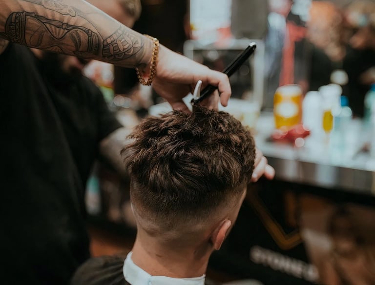 a man getting his hair cut in a barbershop