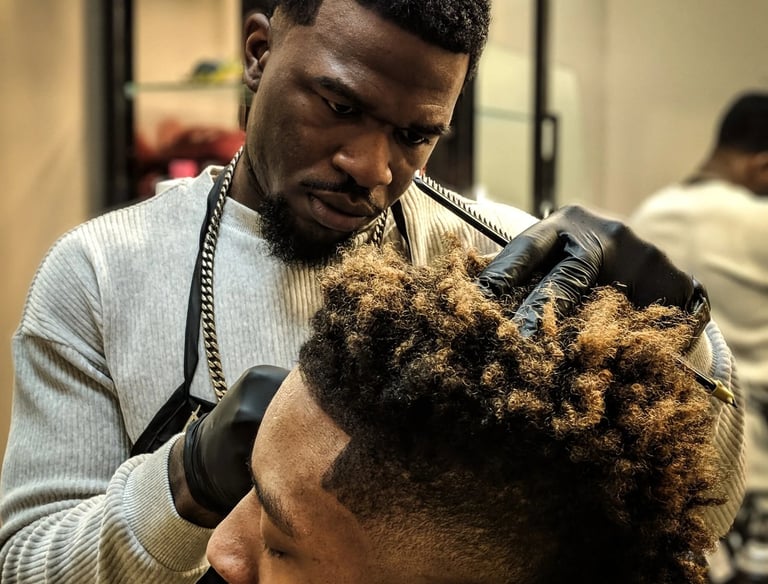a man getting his hair cut off by a barber