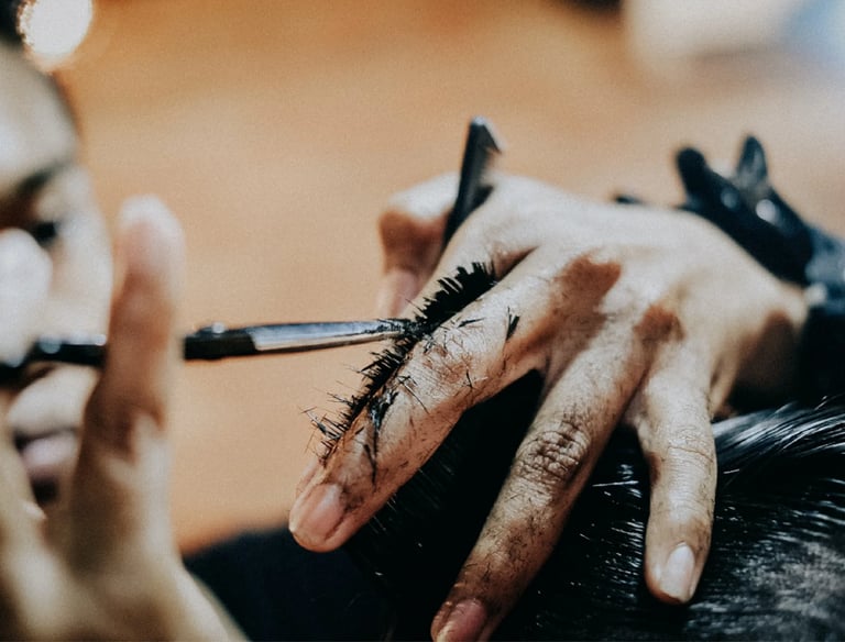 a man is getting his hair cut and styled by a woman