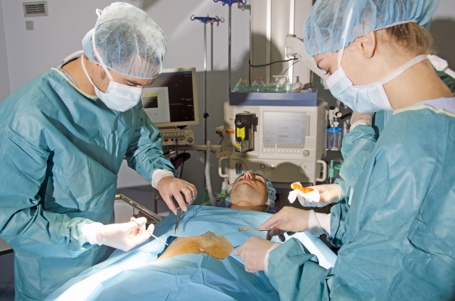 An image of doctor and nurses in an operation room