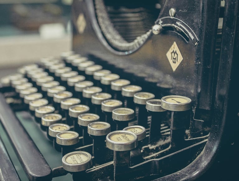 Close-up picture of an antique black typewriter's keys.