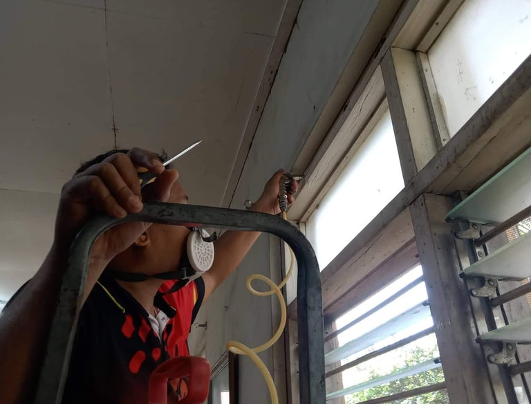 Dumaguete pest control technician sealing holes in preparation for fumigation, ensuring safety