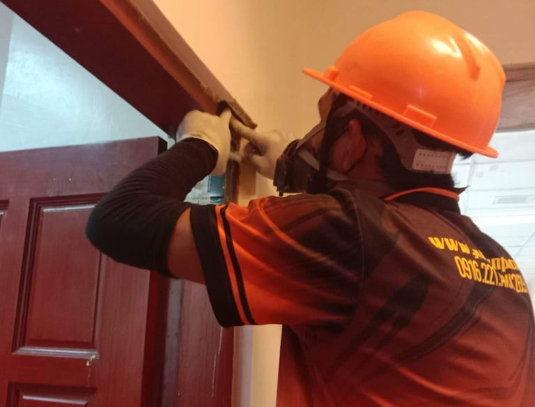 “Dumaguete pest control technician installing termite bait system to protect home from infestation, 