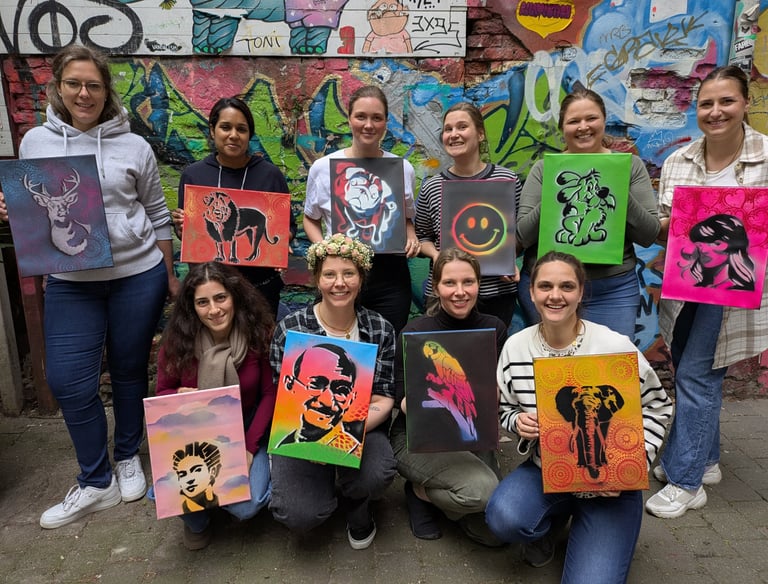 Street art workshop in Hamburg with group holding stencil artworks, Graffiti Workshop mit Teilnehmern und eigenen Kunstwerken