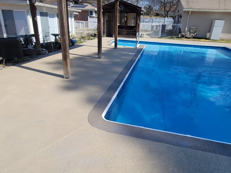 a pool with a patio and a patio area