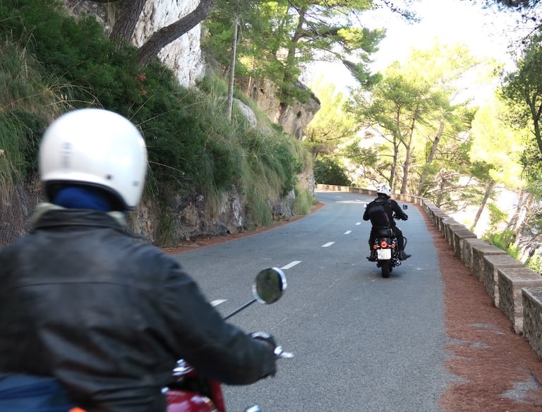 Royal Enfield motorcycle riding along a beautiful road in Mallorca