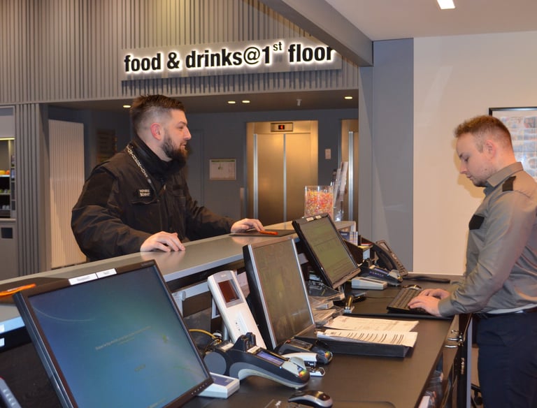 a man standing at a counter with a laptop