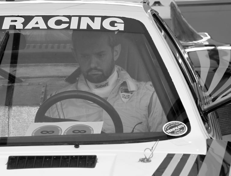 A racing driver sitting in his car at the Goodwood Festival of Speed