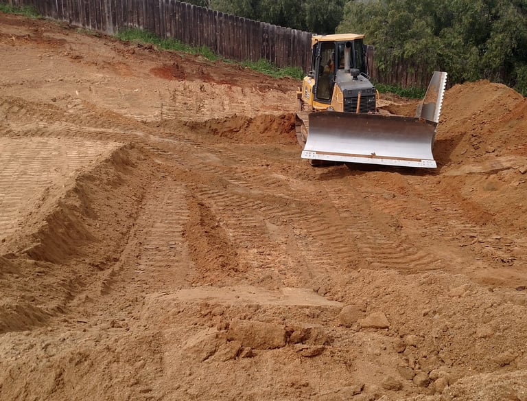 A Bulldozer grading a single family house pad in El Cajon