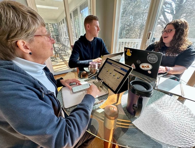 a woman sitting at a table with a man and a woman