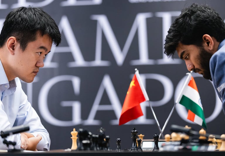 Two players facing each other in chess match