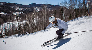 skiing down a hill with a helmet at Val Saint-Come