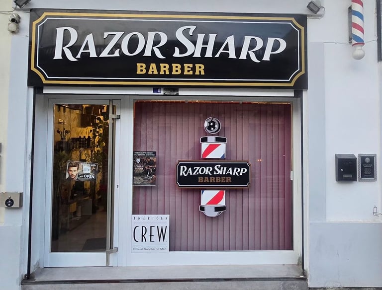 Exterior of Razor Sharp Barber shop storefront with traditional pole and American Crew sign.