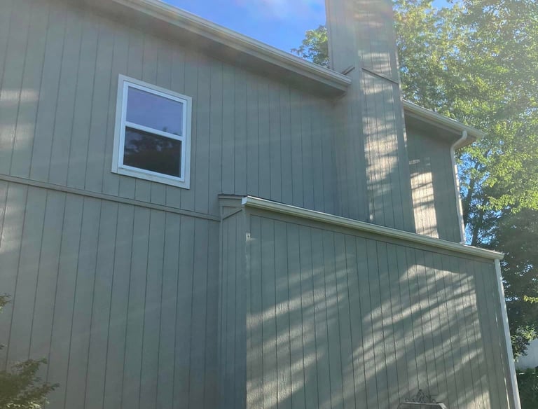 a house with a chimneypipe and a window with a window