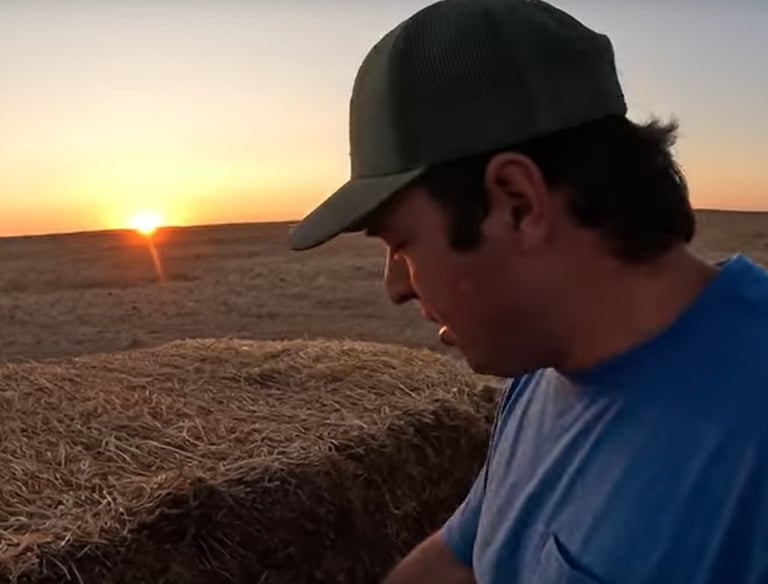 a man in a blue shirt and a hat