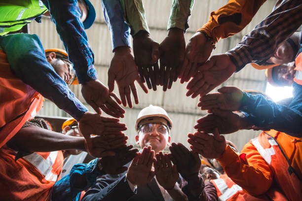 a group of people in a circle with their hands together