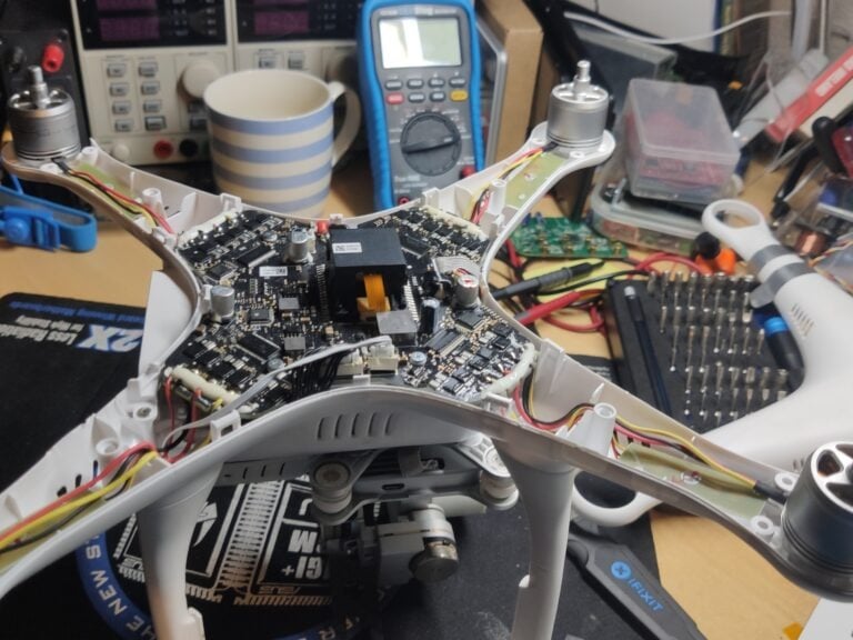 a table with electronics and electronics on it , drone for repair