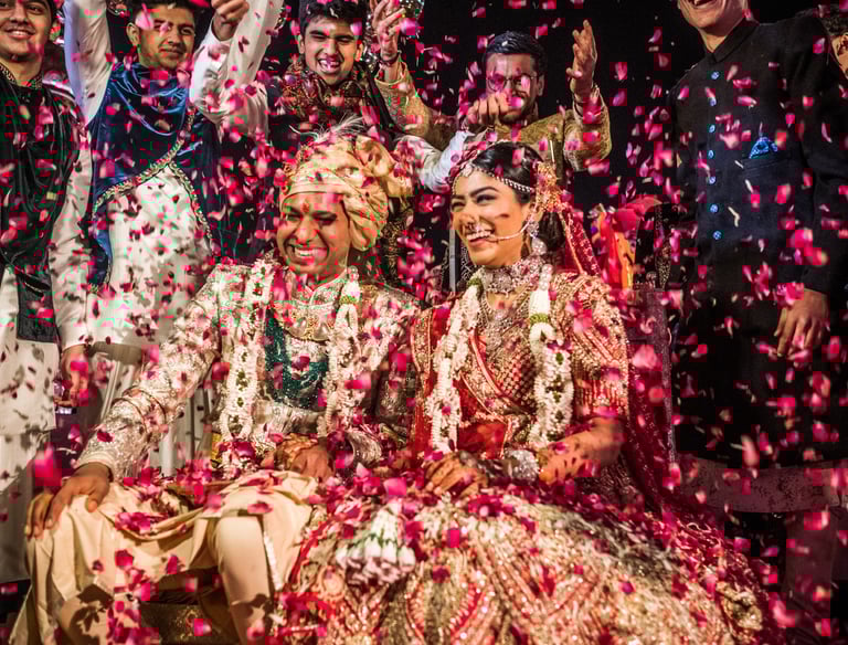 a group of people standing around a man and woman