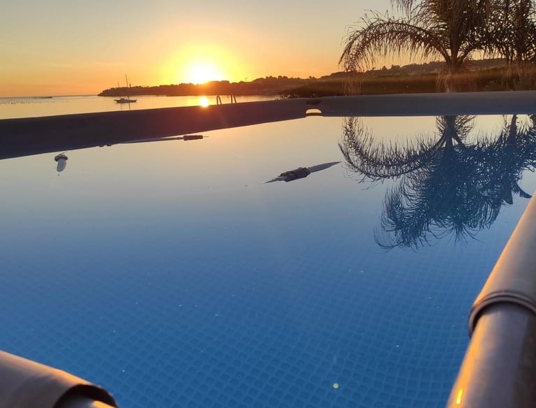 Infinity pool at luxury villa in Sicily with sunset sea view