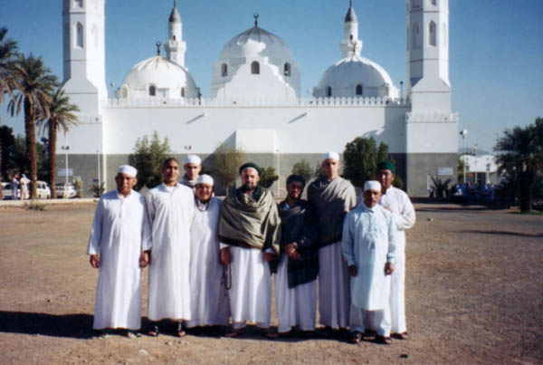 a group of people standing in front of the Quba Mosque in Medina Almunawara