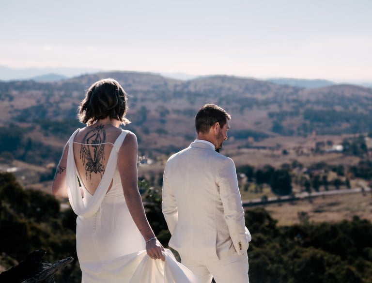 Bride and groom facing away from camera during first look, overlooking canberra hills. Wedding day captured by Canberra photo