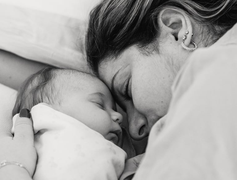 Postpartum Home Care - a woman is holding a baby in her arms