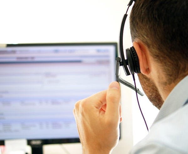 a man in a white shirt and headphones with headphones
