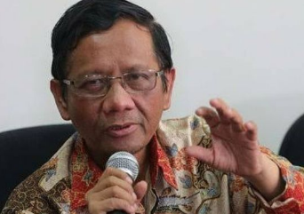 a man in a floral shirt and glasses