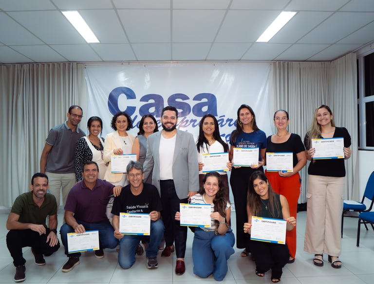 a group of people standing around a table with certificates