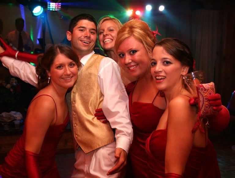 Wedding Party Family in Sheboygan. Hosted by ISDJ. Bridesmaids in red dresses. 