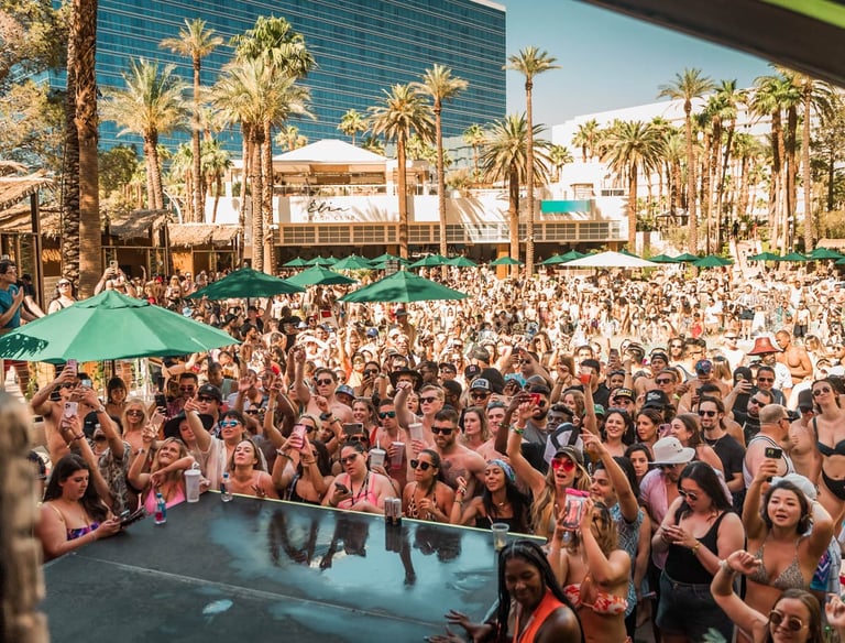 Crowd enjoying an open-bar party bus dayclub tour in Las Vegas with drinks and poolside fun.