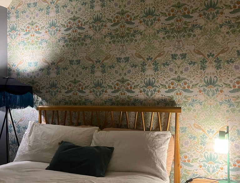 a bed with a lamp on top of it