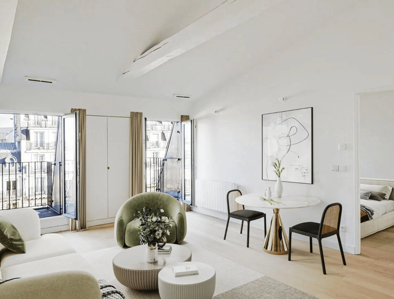 a living room with a table and chairs