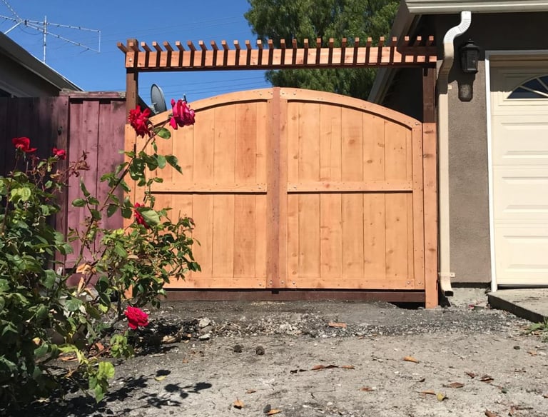 a wooden gated gated in front of a house