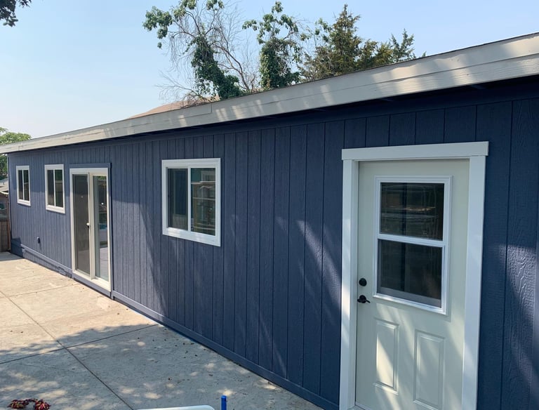 a blue garage with a white door and a white door