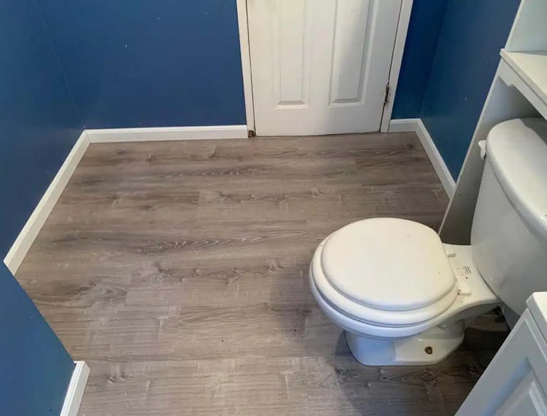 a toilet in a bathroom with a toilet and a toilet paper roll