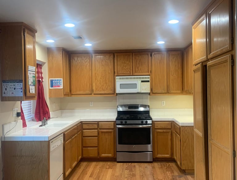 a kitchen with a stove top oven and a microwave