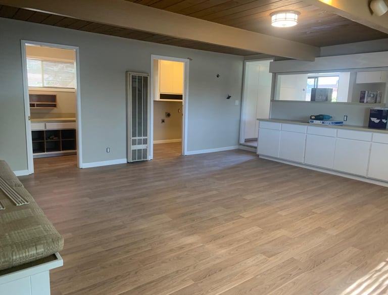 a living room with a couch and a kitchen