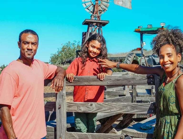 young African American family at a farm