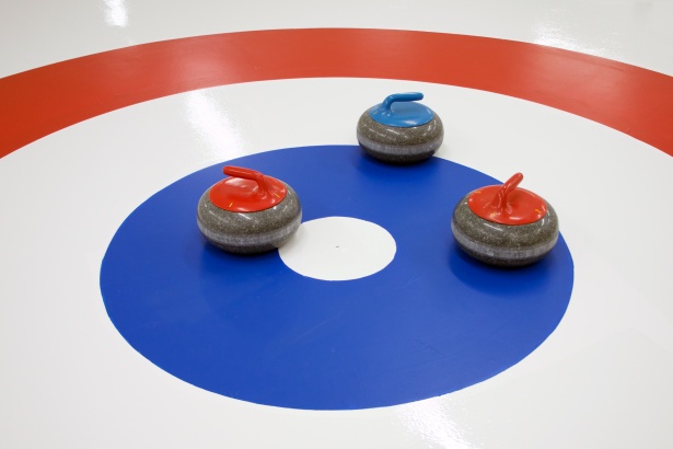 Image of curling stones on house