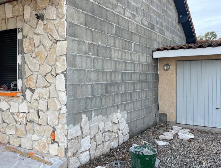 a house with a large window and a green bucket