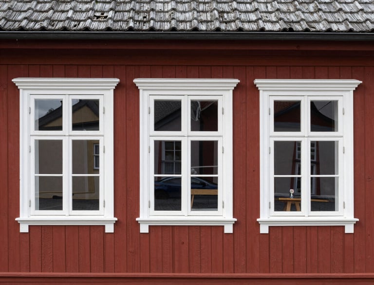 Close-up of a house facade undergoing maintenance and protective treatment.
