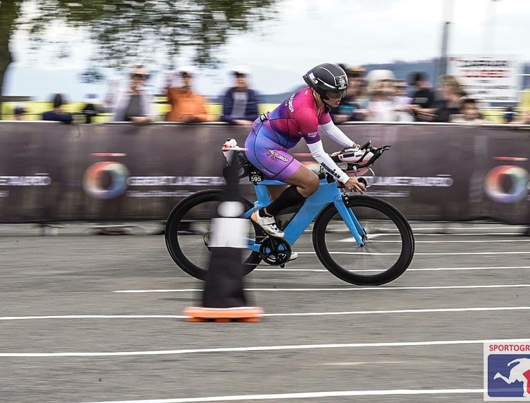 Janice McDonald sporting a CFL Tri Club Kit riding her sky blue time trial bike in IM New Zealand.