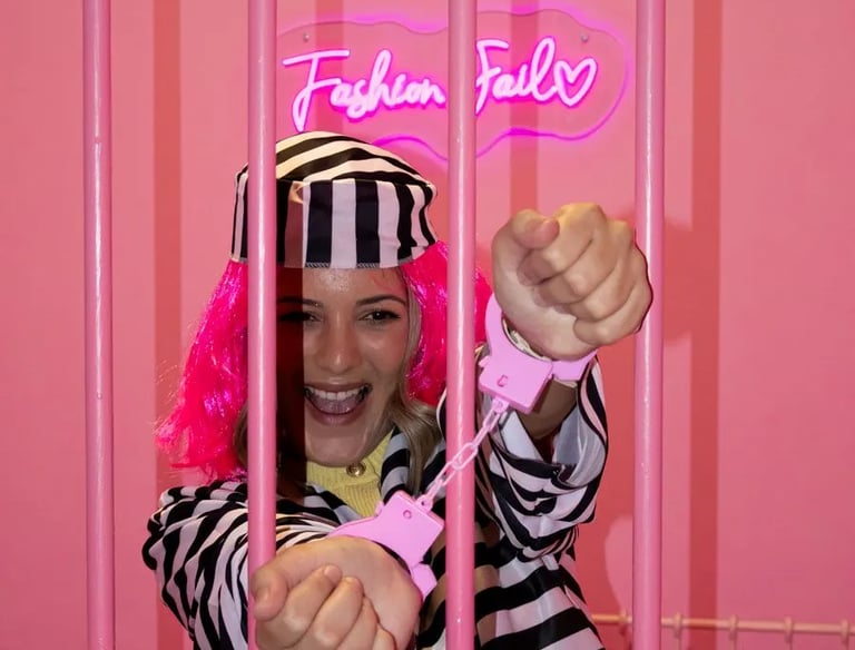 Friends having fun in a pink prison-themed room during a bachelorette party in Split.