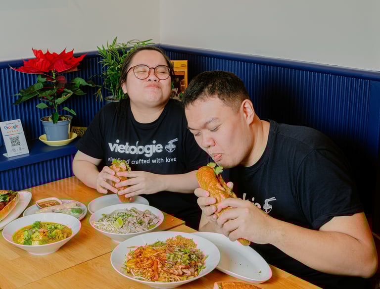 Founders enjoying bánh mì and Vietnamese dishes at a table inside Vietologie in Töölö, Helsinki