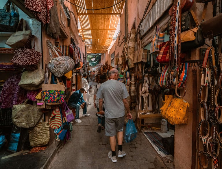 Colorful market stalls bustling with locals in Marrakech’s medina.
