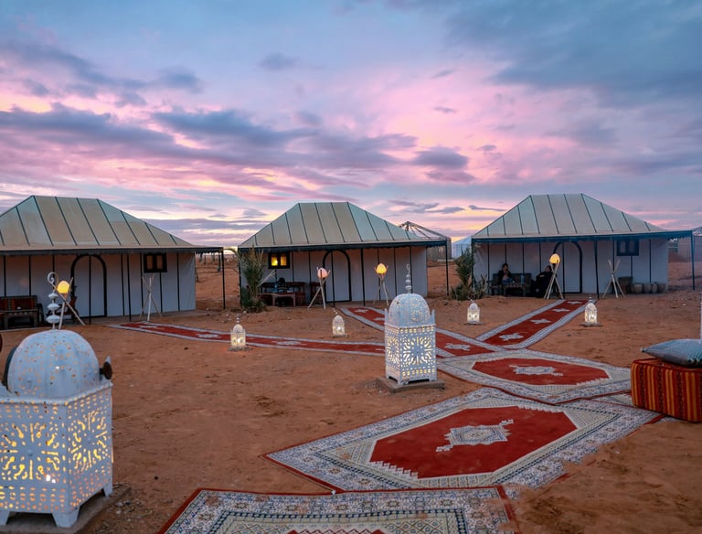 Luxury Sahara desert camp experience with private tents and evening atmosphere in Morocco