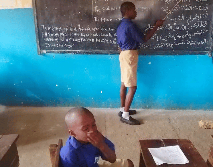 Children learning and teaching Qur’an in a Sierra Leone village school – Maakitheena
