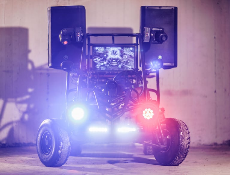 Custom off-road go-kart equipped with high-powered audio speakers and vibrant DJ party lights.